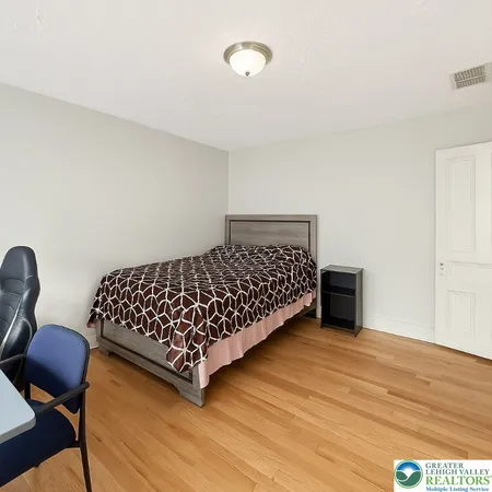 a bedroom with a bed and a dresser