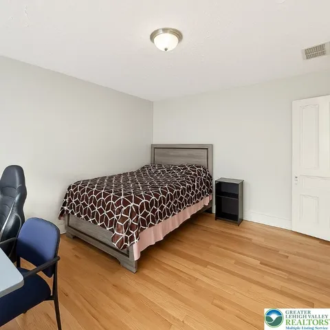 a bedroom with a bed and a dresser