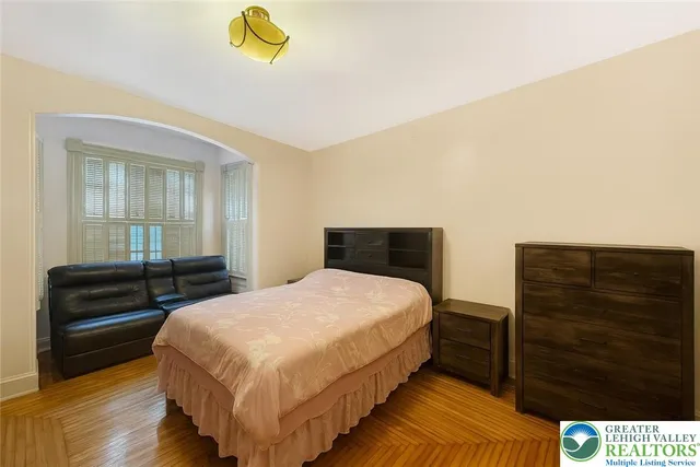 a bedroom with a bed and a dresser