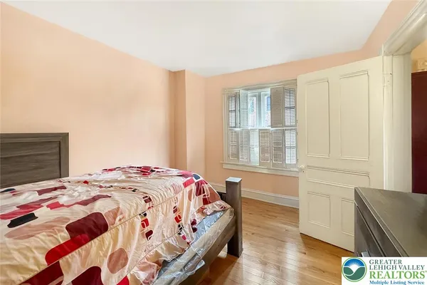 a bedroom with a bed and a dresser