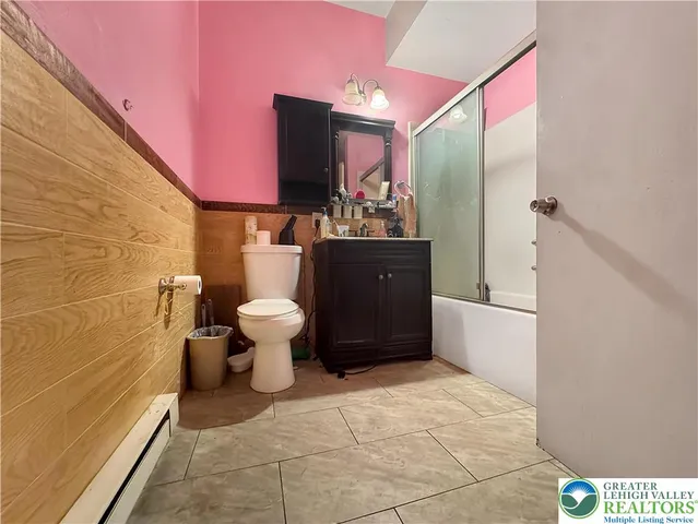 a bathroom with a toilet a sink and a mirror