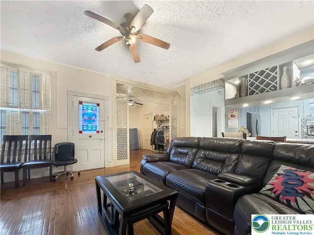 a living room with furniture and a wooden floor