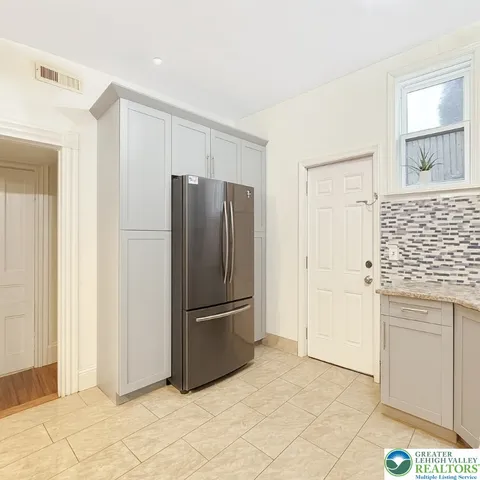 a kitchen with granite countertop a stove sink and cabinets
