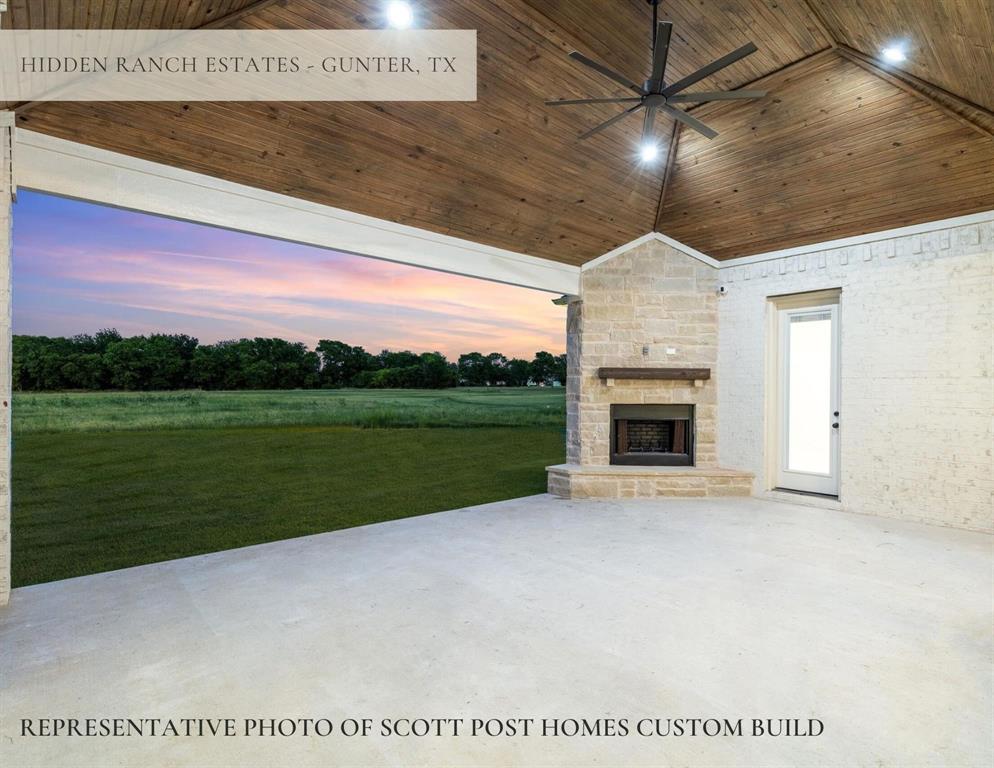 1387 McConnell Road Gunter, TX 75058 - Photo 8 of 15 Covered outdoor patio with a stone fireplace, wood-planked vaulted ceiling, and a large ceiling fan