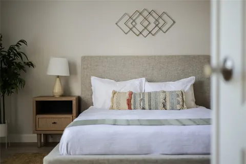 a bedroom with a bed and a lamp on table