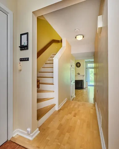 a view of a hallway with wooden floor and entryway