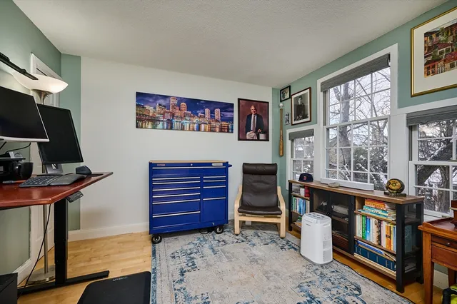 a view of a workspace with furniture and a window