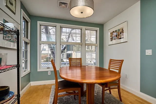 a view of a dining room with furniture window and wooden floor