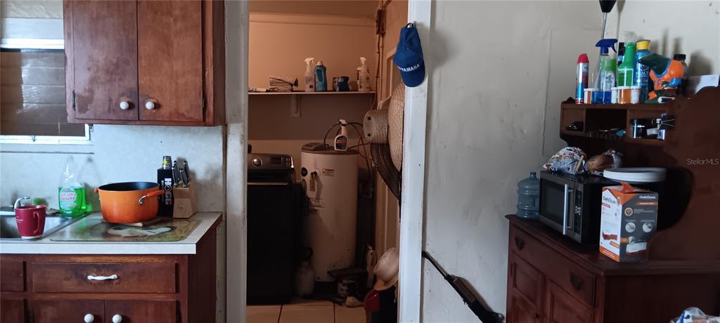 555 Lee Road Jacksonville, FL 32225 - Photo 22 of 67 a room with a refrigerator and cabinets