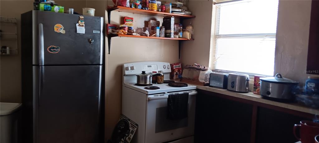 555 Lee Road Jacksonville, FL 32225 - Photo 23 of 67 a kitchen with a refrigerator and a stove