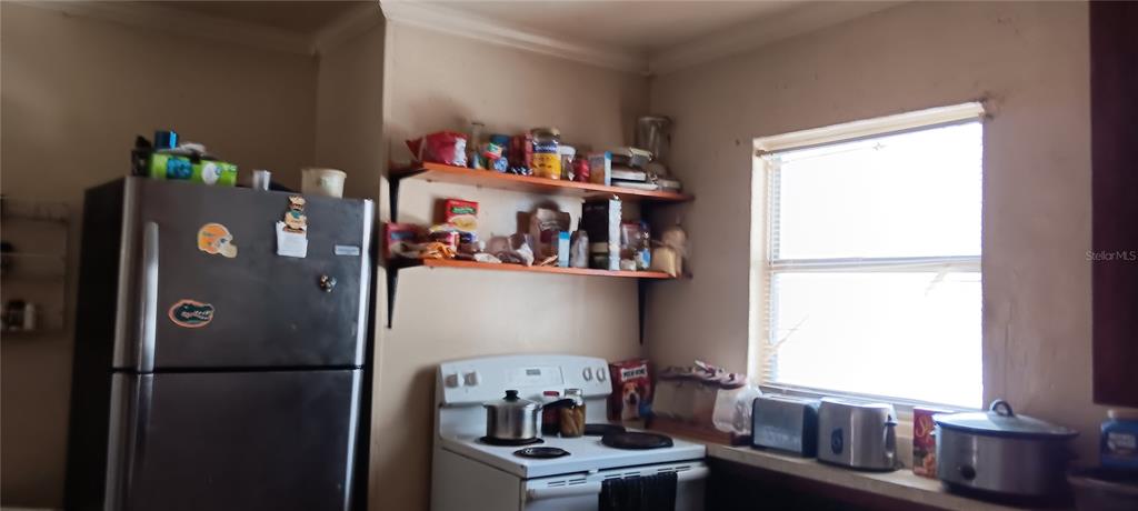 555 Lee Road Jacksonville, FL 32225 - Photo 24 of 67 a white refrigerator freezer sitting in a kitchen