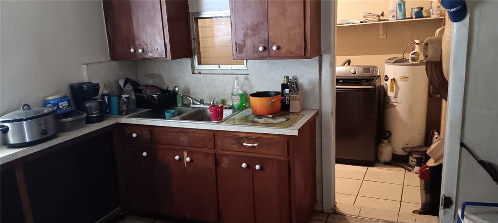 555 Lee Road Jacksonville, FL 32225 - Photo 25 of 67 a kitchen with a sink refrigerator and cabinets
