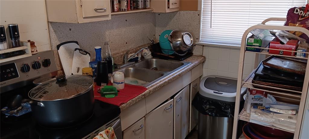 555 Lee Road Jacksonville, FL 32225 - Photo 49 of 67 a kitchen with a sink stove and cabinets