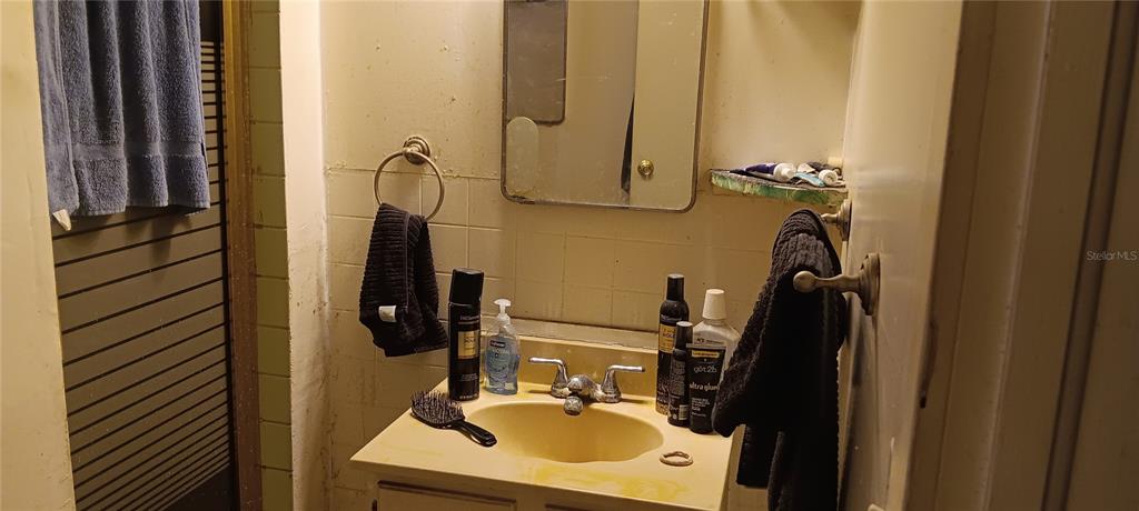 555 Lee Road Jacksonville, FL 32225 - Photo 57 of 67 a bathroom with a sink a mirror and shower view