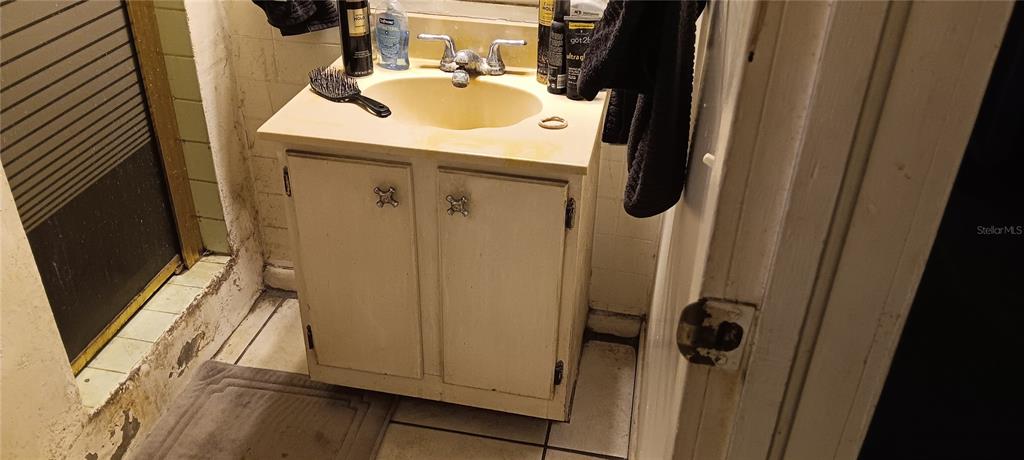 555 Lee Road Jacksonville, FL 32225 - Photo 58 of 67 a bathroom with a sink a mirror and shower