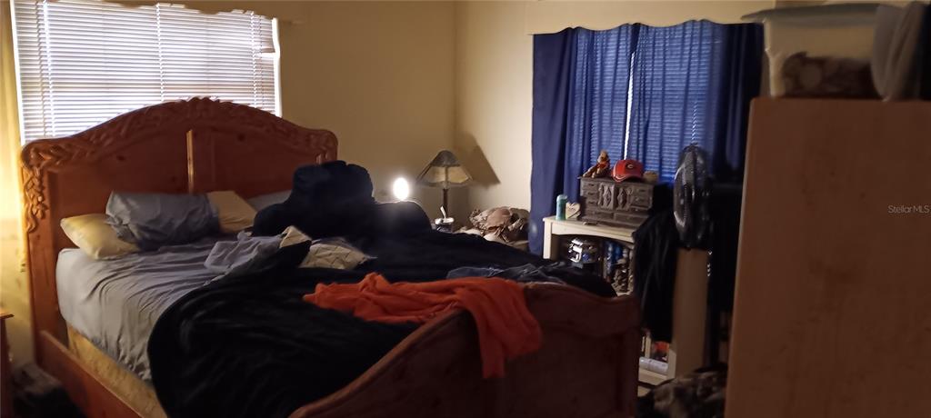 555 Lee Road Jacksonville, FL 32225 - Photo 64 of 67 a bed sitting in a bedroom next to a window and dresser