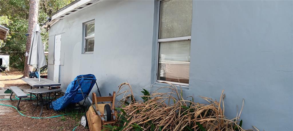 555 Lee Road Jacksonville, FL 32225 - Photo 10 of 67 a bed sitting in a bedroom next to a window and a chair