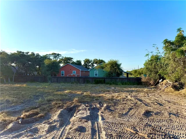 a view of a yard with a house in the background