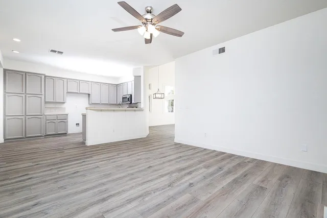 a view of a kitchen with a sink and a refrigerator