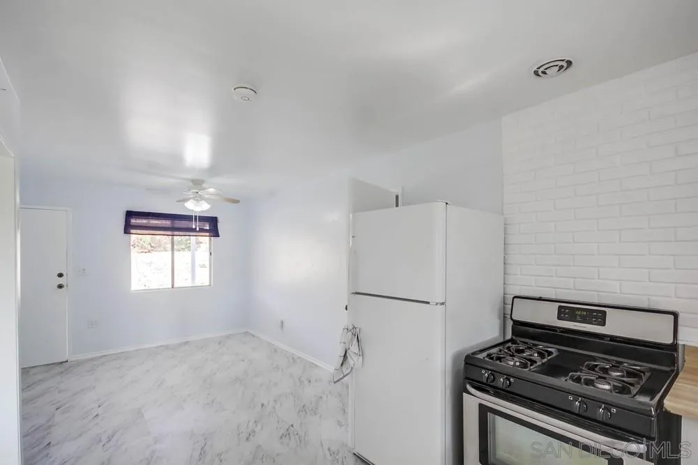 9464 Stoyer Drive Santee, CA 92071 - Photo 11 of 25 a kitchen with a stove and a refrigerator