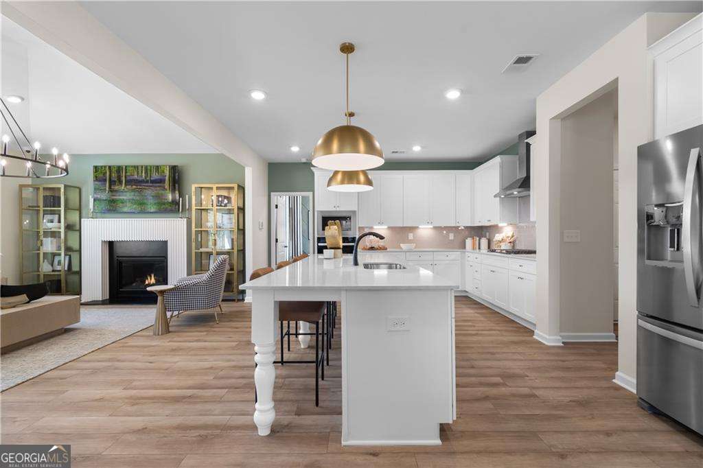 420 Hartsfield Road McDonough, GA 30253 - Photo 15 of 44 a kitchen with granite countertop a stove oven and a fireplace