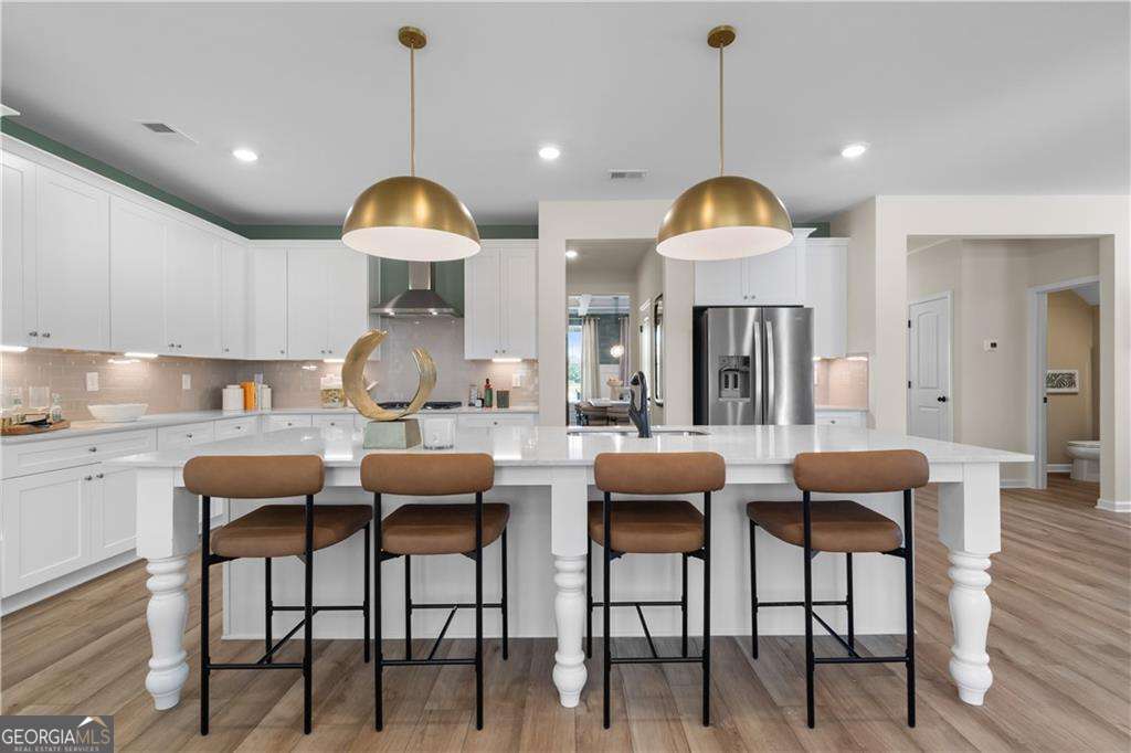 420 Hartsfield Road McDonough, GA 30253 - Photo 17 of 44 a dining room with furniture and wooden floor
