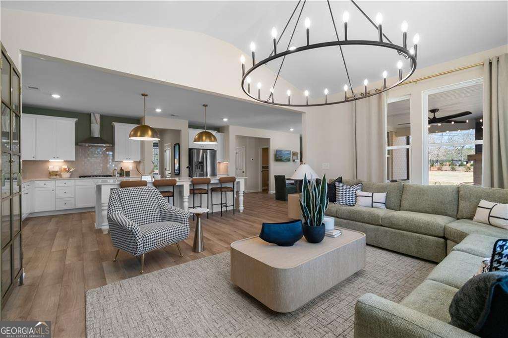 420 Hartsfield Road McDonough, GA 30253 - Photo 21 of 44 a living room with furniture a chandelier and kitchen view