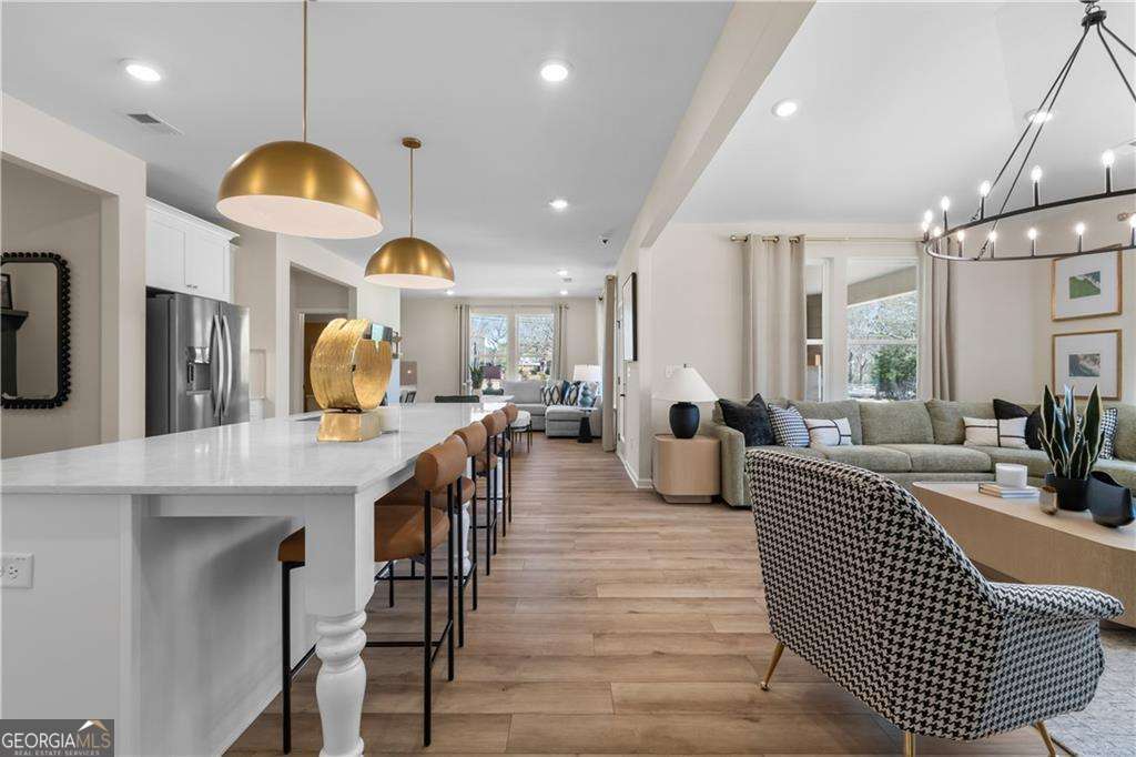 420 Hartsfield Road McDonough, GA 30253 - Photo 25 of 44 a living room with lots of furniture and a chandelier