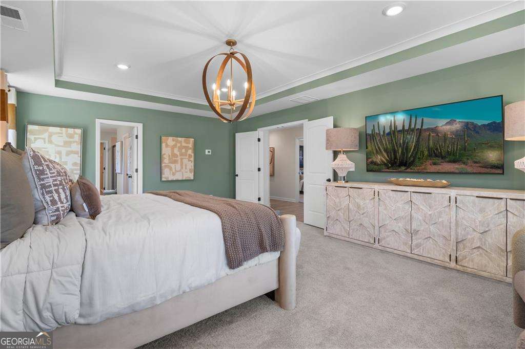 420 Hartsfield Road McDonough, GA 30253 - Photo 37 of 44 a spacious bedroom with a bed and a large mirror on the dresser