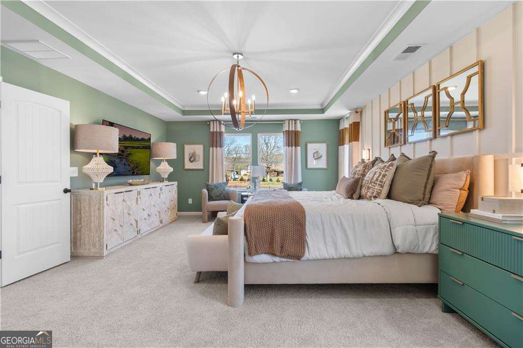 420 Hartsfield Road McDonough, GA 30253 - Photo 38 of 44 a spacious bedroom with a bed couch chandelier and a window