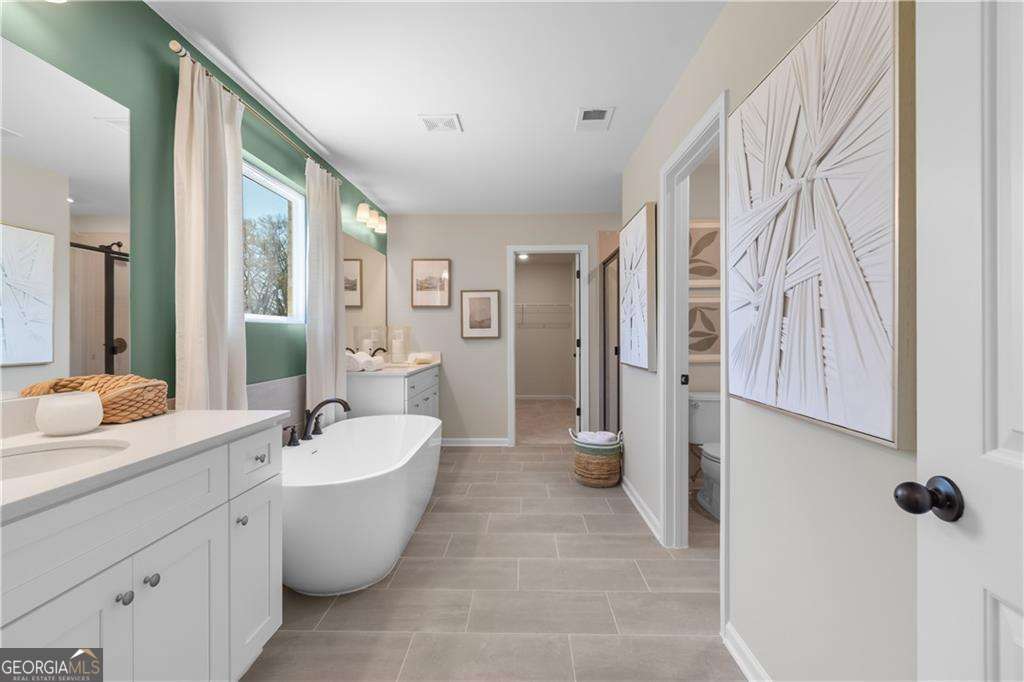 420 Hartsfield Road McDonough, GA 30253 - Photo 39 of 44 a large spacious bathroom with a bathtub shower and sink