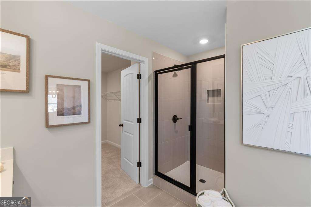 420 Hartsfield Road McDonough, GA 30253 - Photo 41 of 44 a bathroom with a shower and a mirror