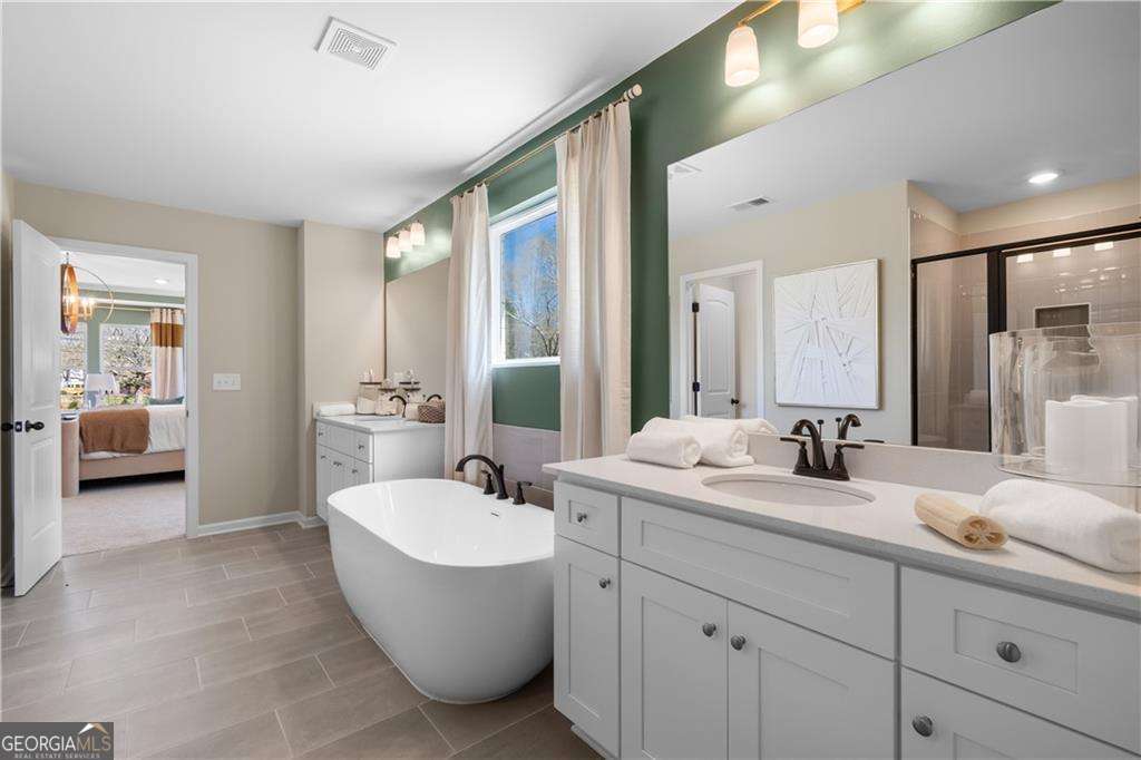 420 Hartsfield Road McDonough, GA 30253 - Photo 42 of 44 a bathroom with a double vanity sink a mirror and a