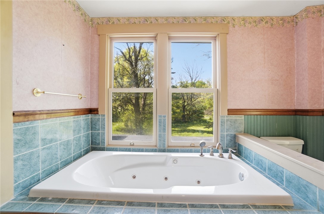 1444 Eagle City Road Springfield, OH 45504 - Photo 38 of 50 Relax in this jetted soaking tub, offering serene views of the outdoors.