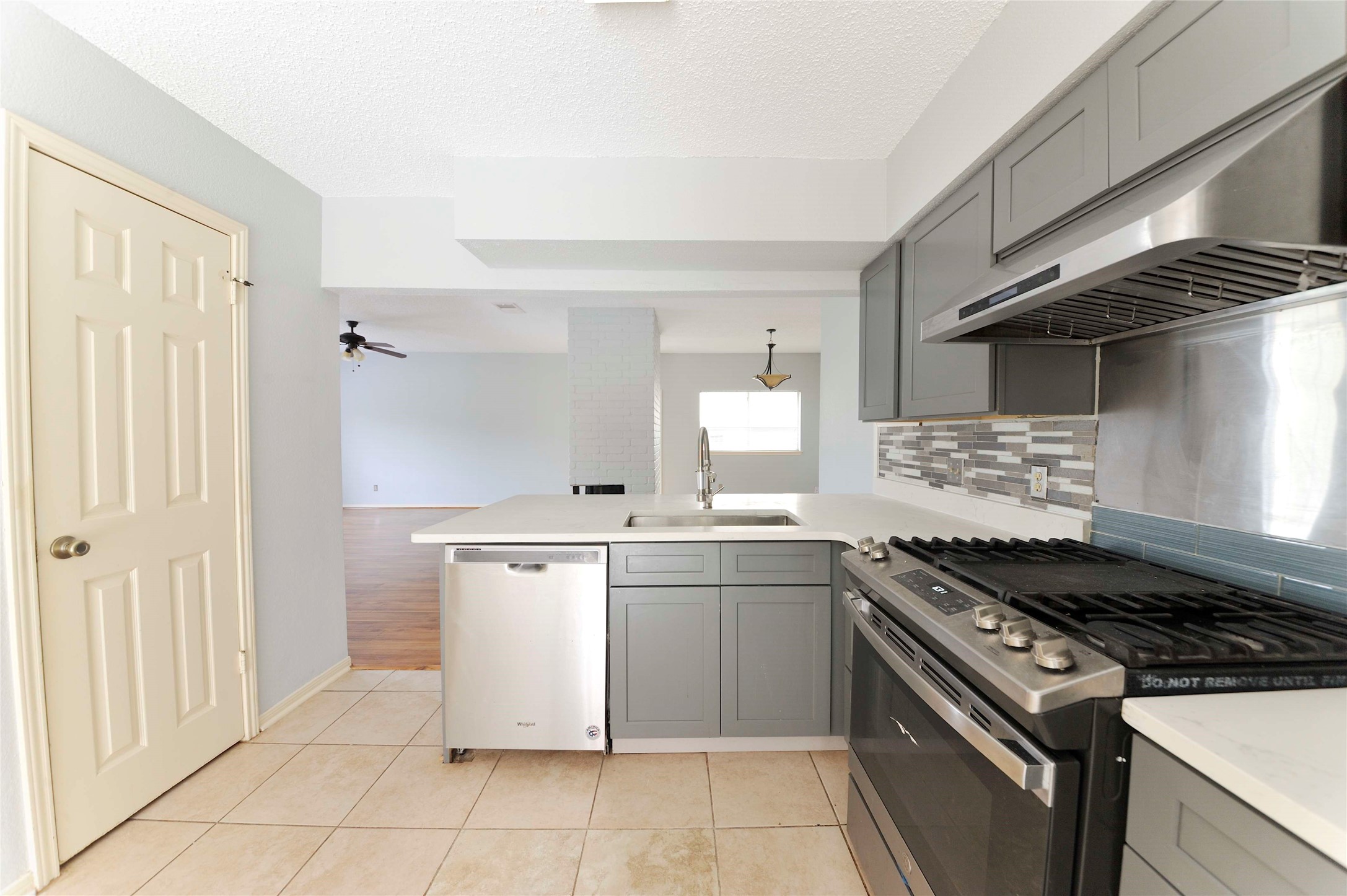 3219 Pecan Draw Court Sugar Land, TX 77479 - Photo 4 of 20 a kitchen with a stove sink and cabinets