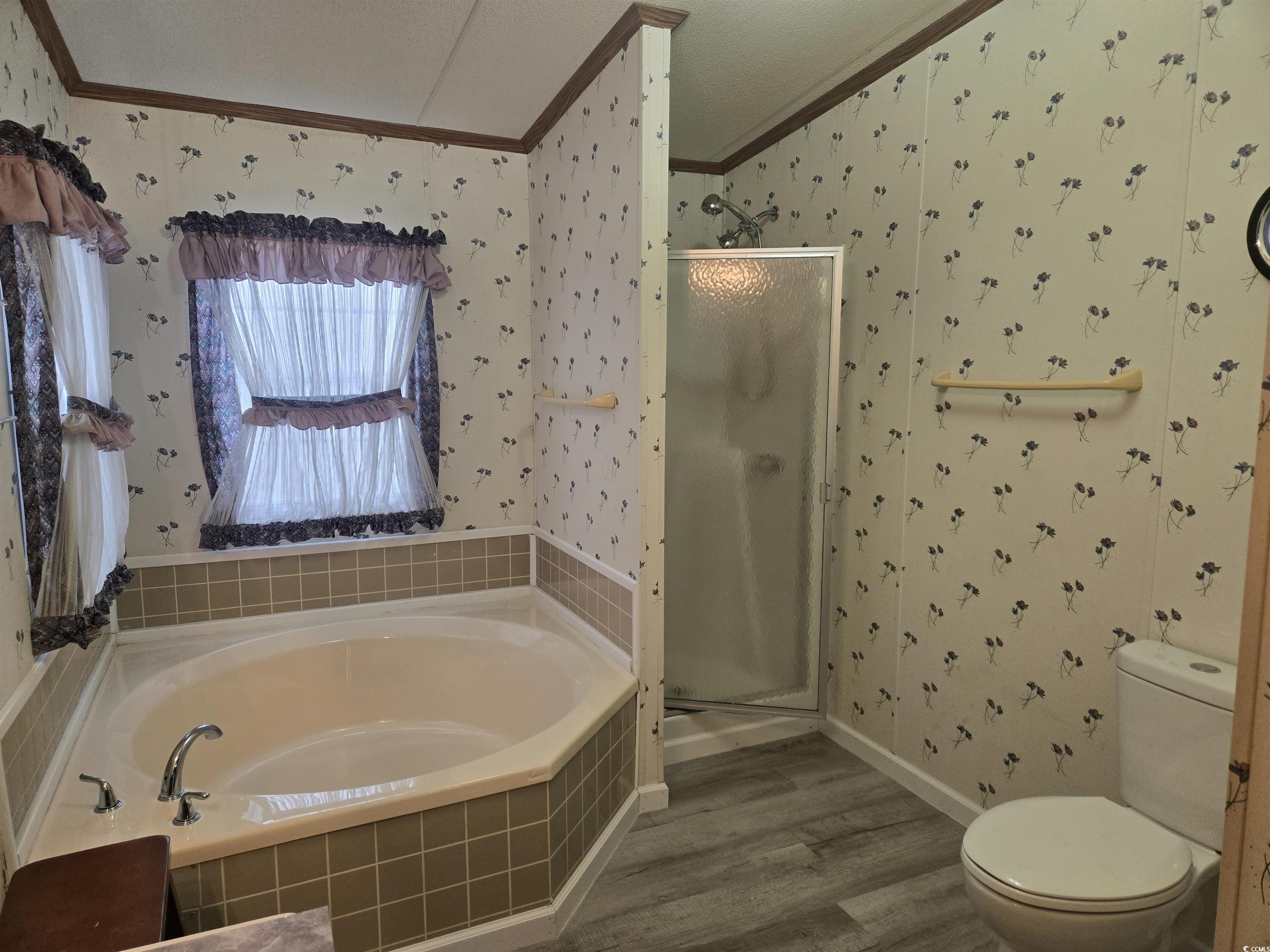 326 Tunnoch Road Murrells Inlet, SC 29576 - Photo 19 of 22 Full bath featuring crown molding, a shower stall, wallpapered walls, wood finished floors, and a garden tub