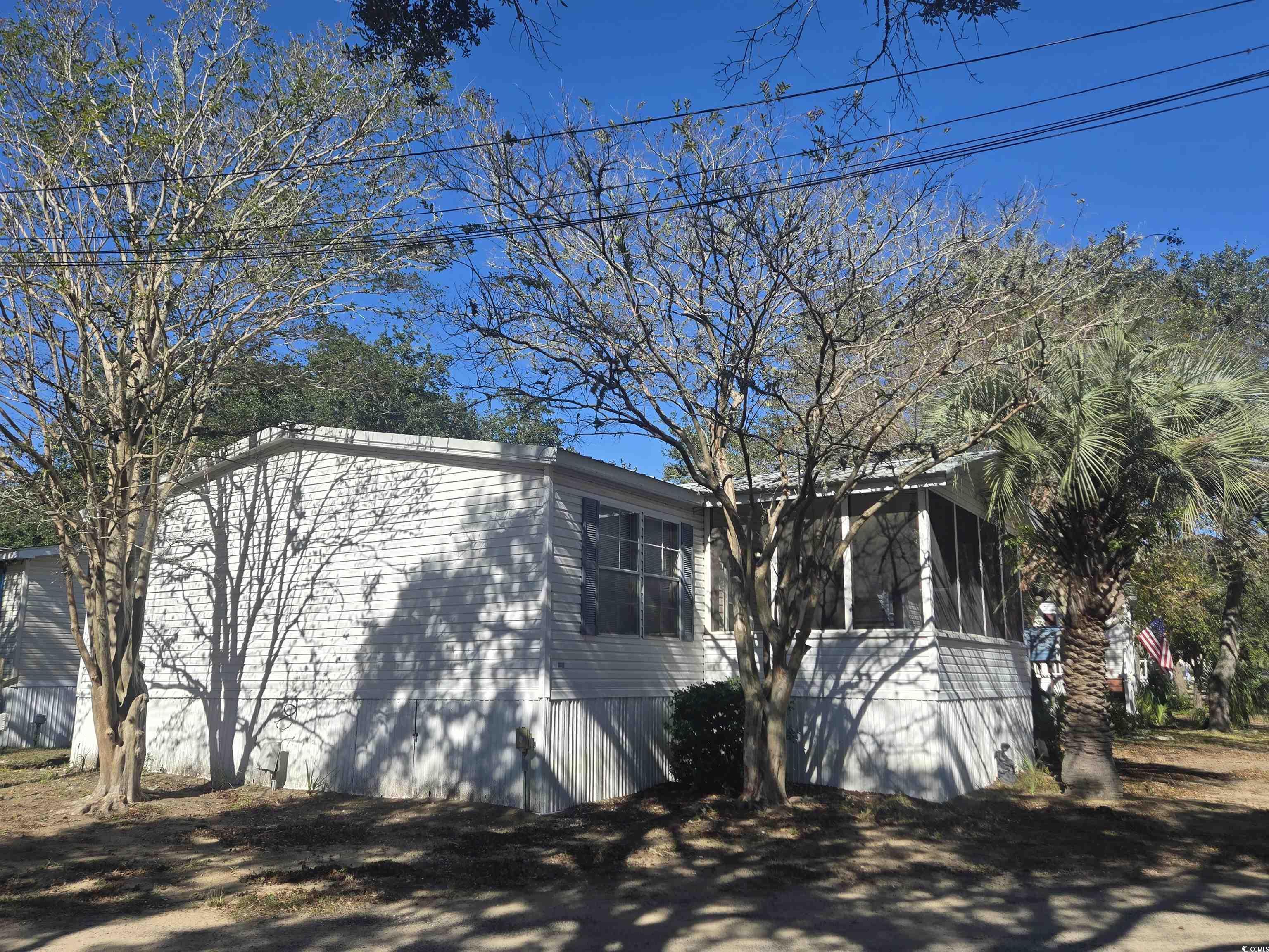 326 Tunnoch Road Murrells Inlet, SC 29576 - Photo 3 of 22 View of home's exterior with a sunroom