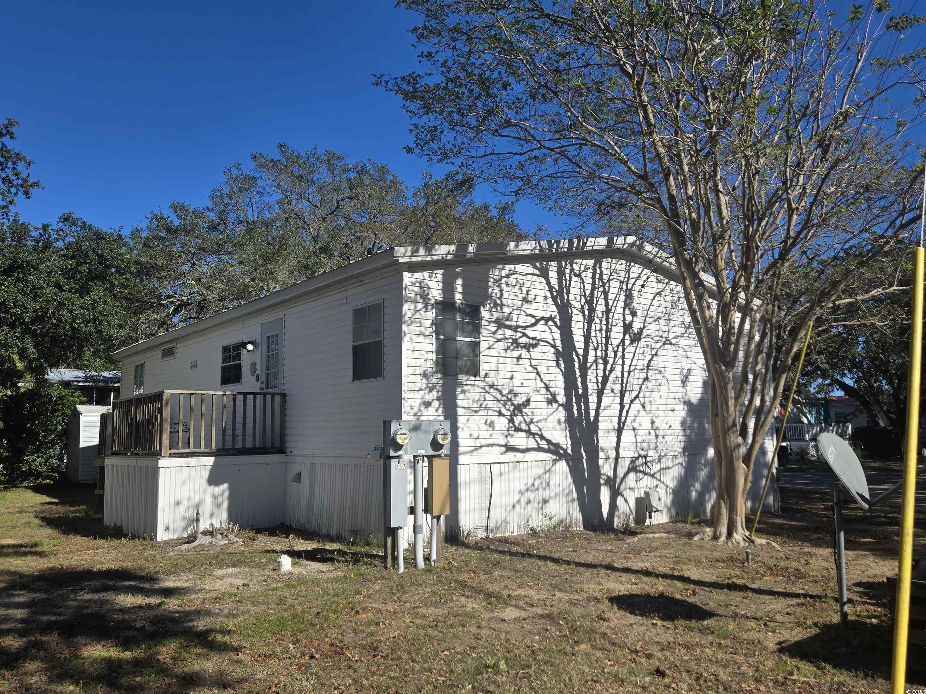 326 Tunnoch Road Murrells Inlet, SC 29576 - Photo 4 of 22 View of side of property featuring a yard and a wooden deck
