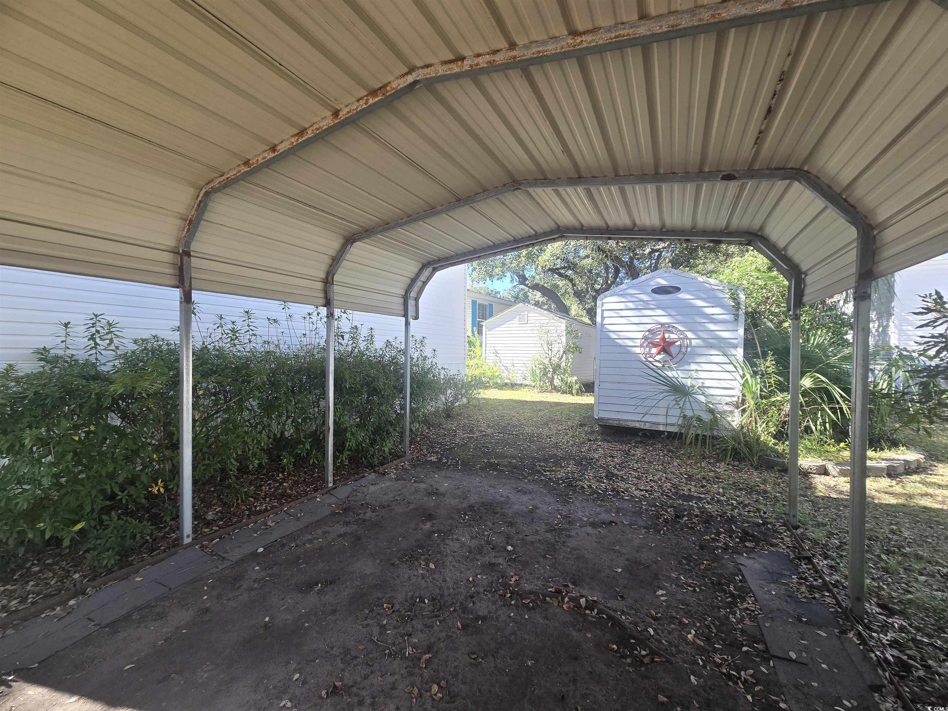 326 Tunnoch Road Murrells Inlet, SC 29576 - Photo 6 of 22 View of parking / parking lot with a storage shed