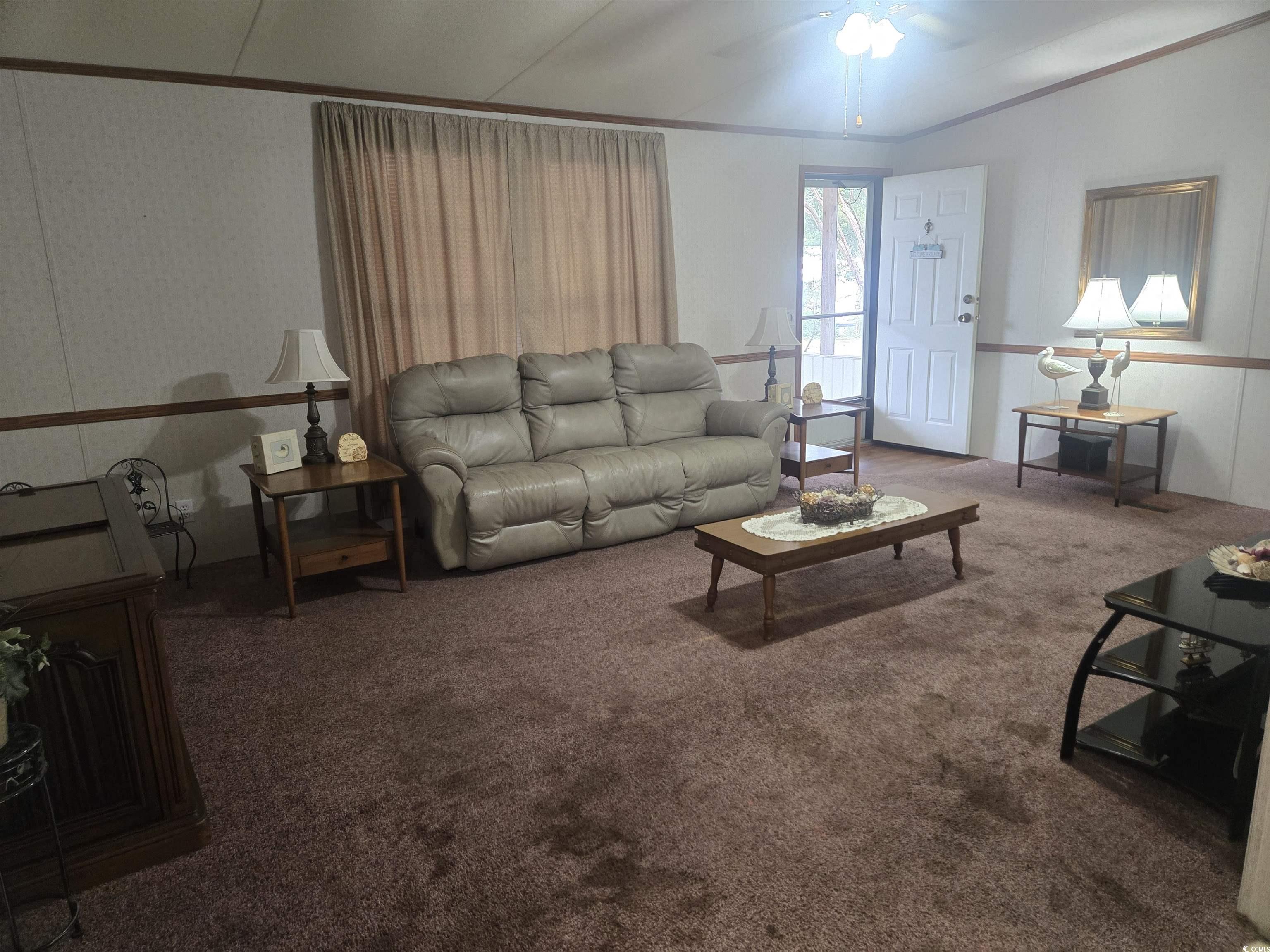 326 Tunnoch Road Murrells Inlet, SC 29576 - Photo 9 of 22 Carpeted living area featuring crown molding and a ceiling fan