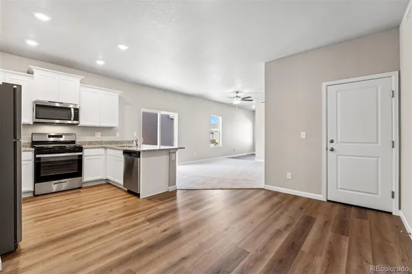 a kitchen with stainless steel appliances a refrigerator and a stove top oven