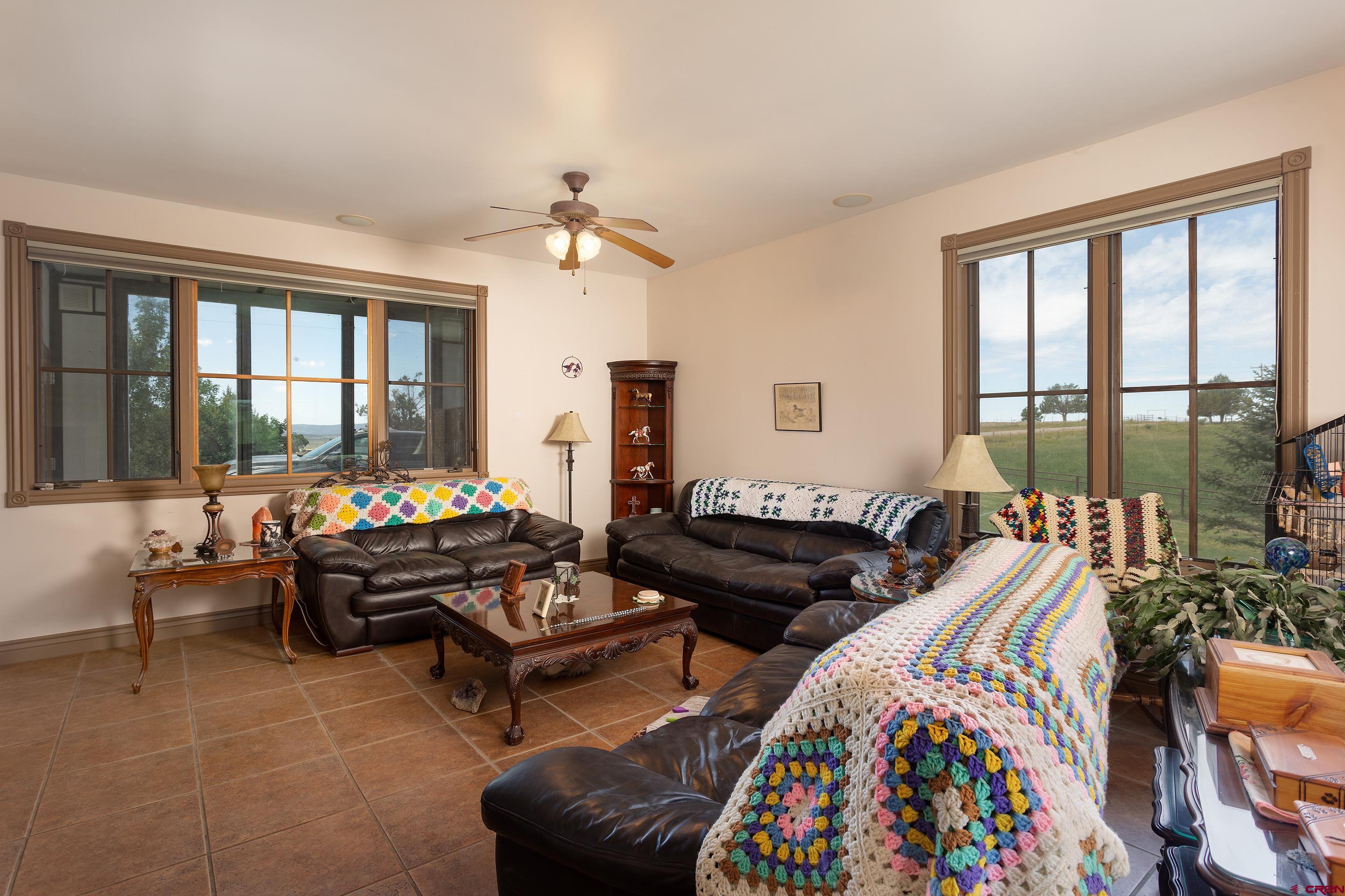 1747 County Road 514 Ignacio, CO 81137 - Photo 11 of 35 a living room with furniture and a floor to ceiling window