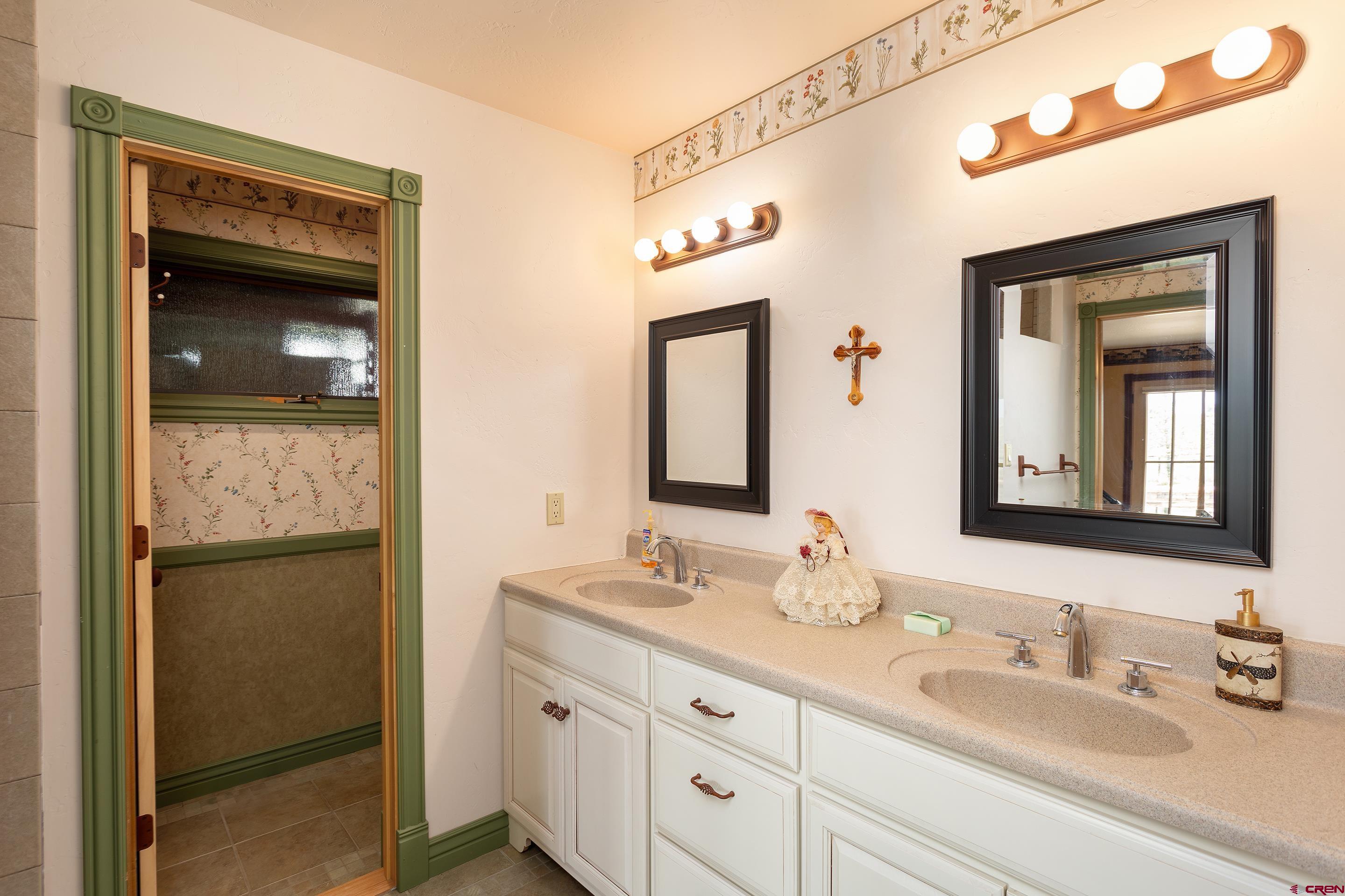 1747 County Road 514 Ignacio, CO 81137 - Photo 14 of 35 a bathroom with a double vanity sink and a mirror