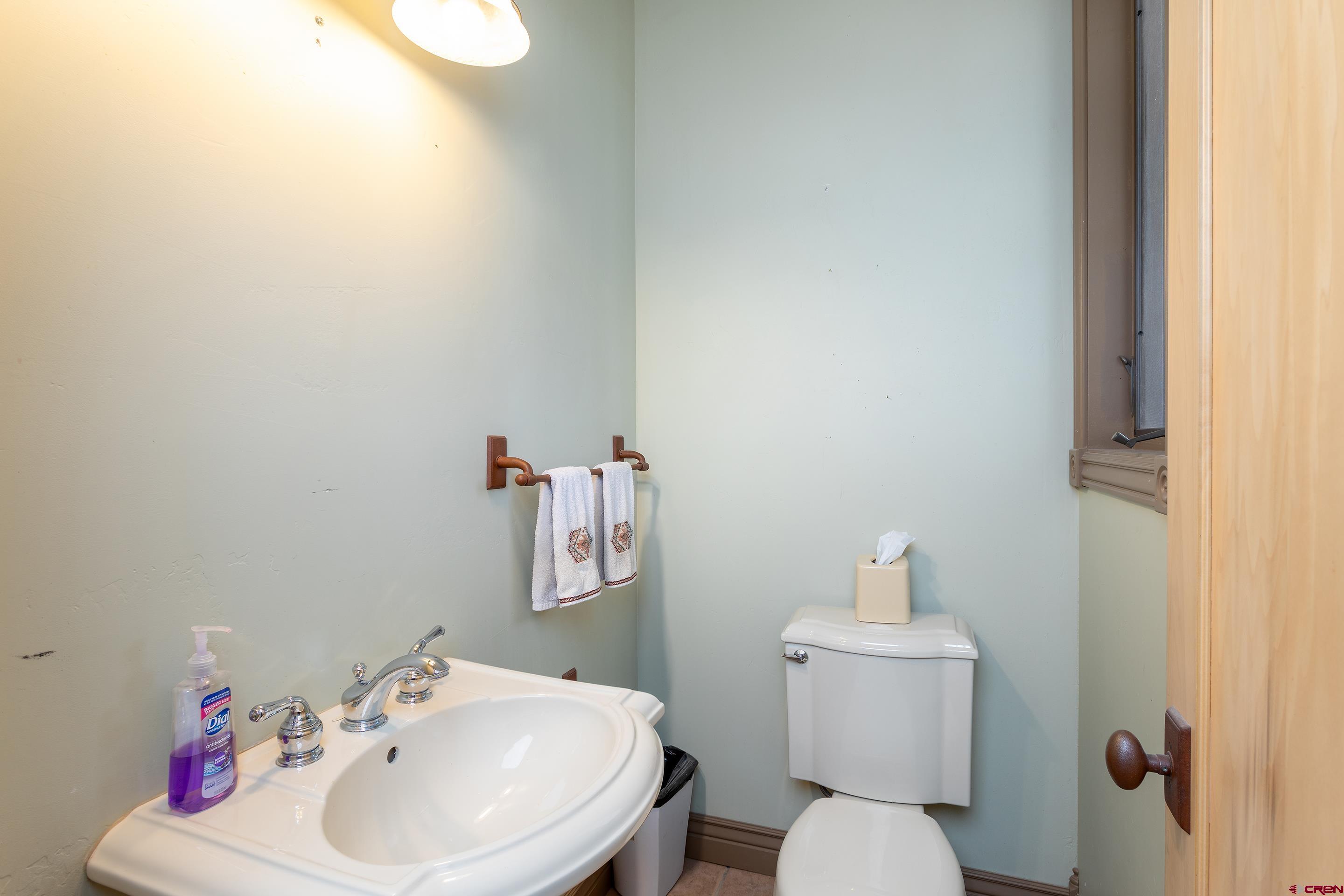 1747 County Road 514 Ignacio, CO 81137 - Photo 22 of 35 a bathroom with a sink mirror and toilet