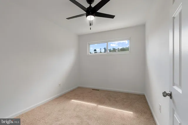 a view of a room with wooden floor and windows