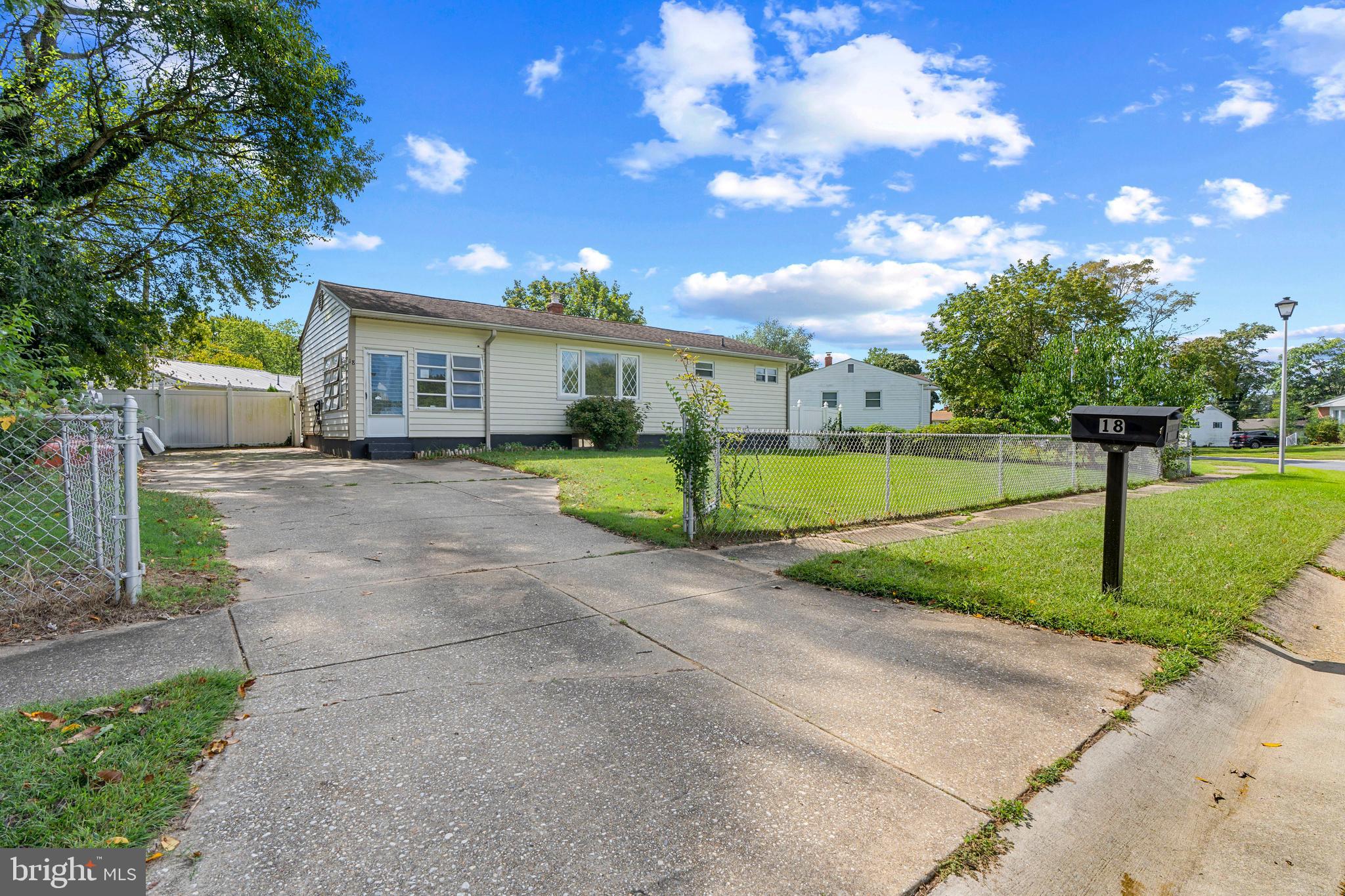 18 John Collins Circle Dover, DE 19904 - Photo 2 of 17 a view of a house with a big yard and large trees