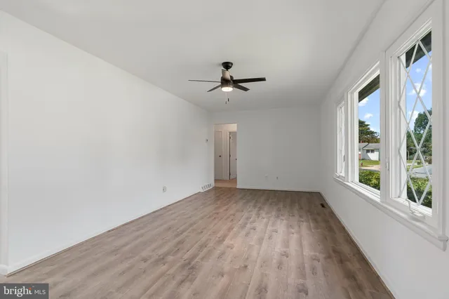 wooden floor in an empty room with a window