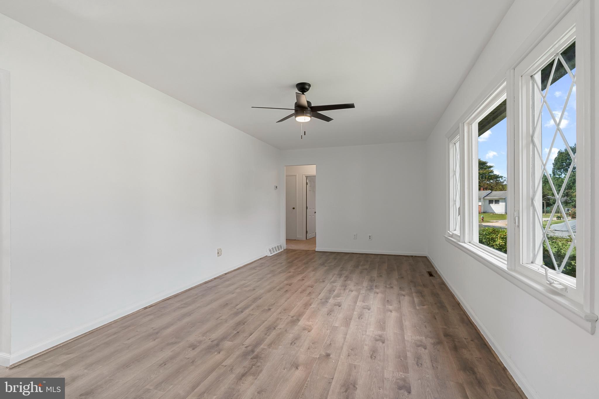 18 John Collins Circle Dover, DE 19904 - Photo 3 of 17 wooden floor in an empty room with a window