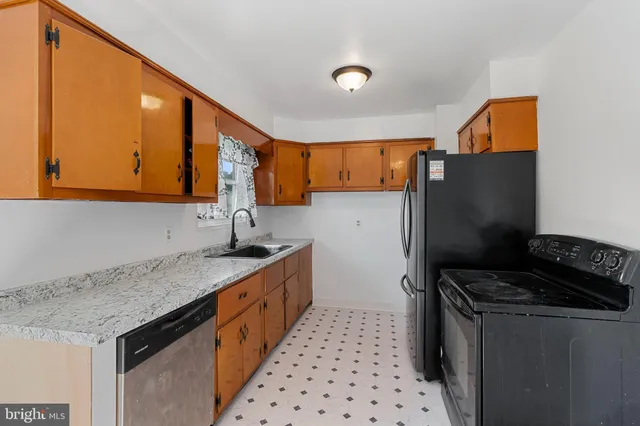 a kitchen with stainless steel appliances a sink stove and refrigerator
