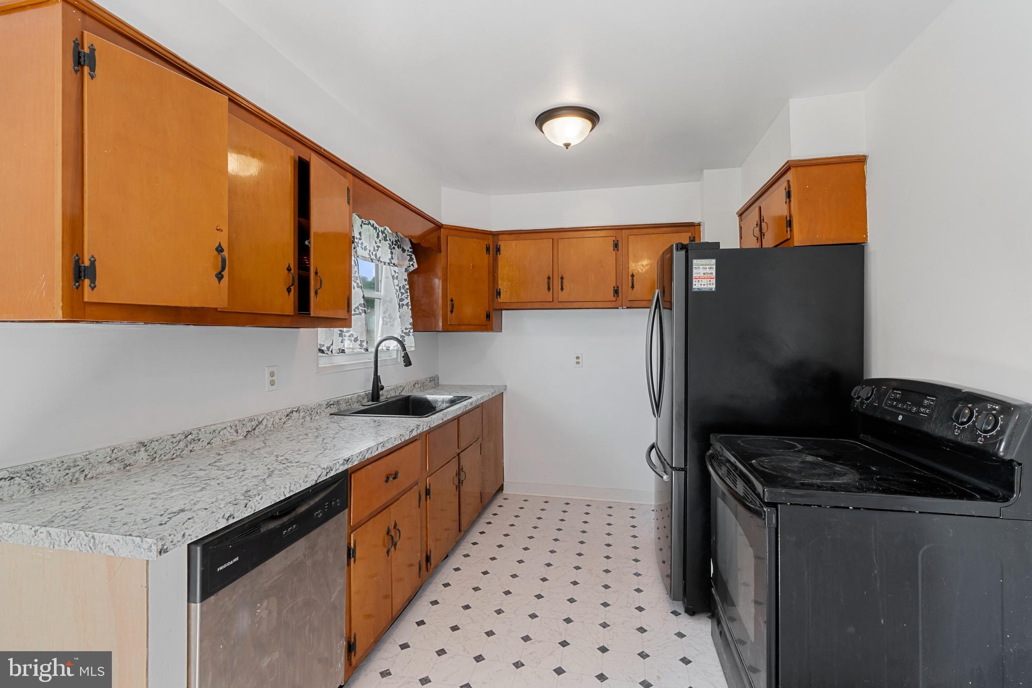 18 John Collins Circle Dover, DE 19904 - Photo 5 of 17 a kitchen with stainless steel appliances a sink stove and refrigerator